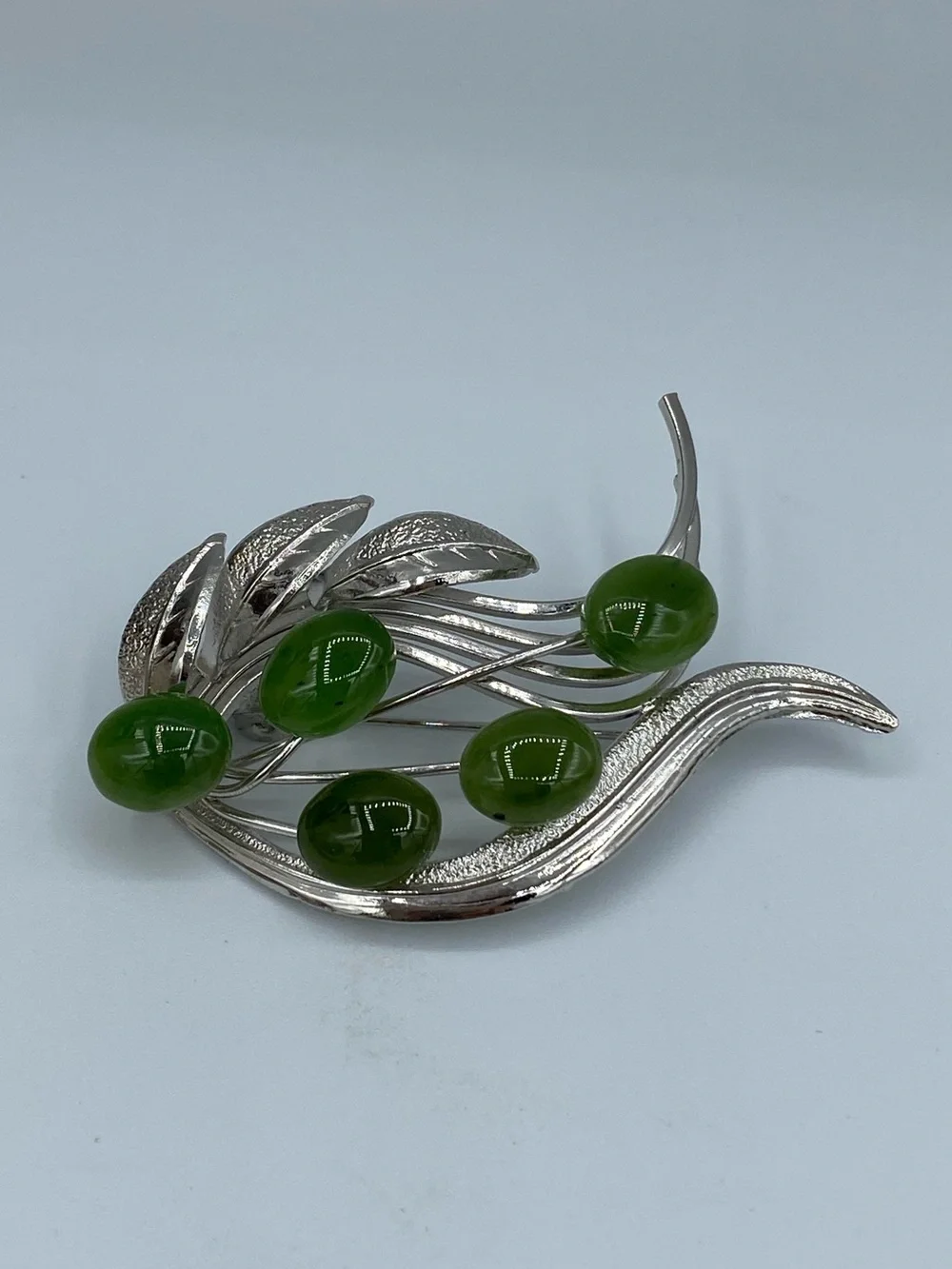 Silver-Tone Brooch with Glossy Green Cabochons